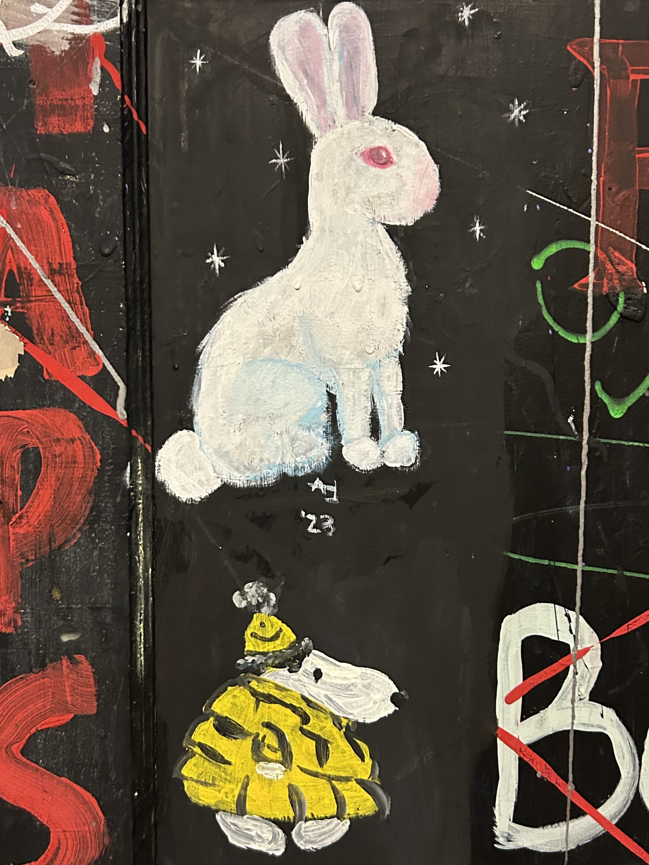 graffiti of white rabbbit and snoopy in a yellow puffer jacket